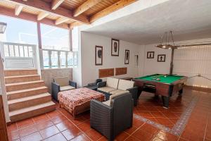 a living room with a pool table and ping pong ball at ITY House in Playa Honda