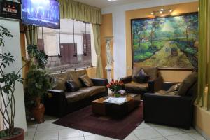 a living room with couches and a flat screen tv at Retamas Hotel in Cajamarca