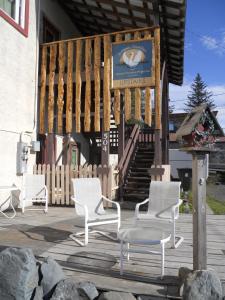 a group of chairs and a table on a deck at A Swan Nest Inn in Seward