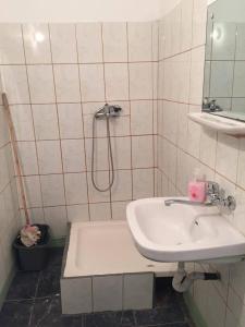 a white bathroom with a sink and a shower at Bungalow Eforie Nord in Eforie Nord