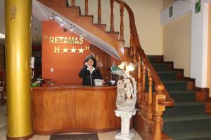a woman standing at a counter in a building at Retamas Hotel in Cajamarca