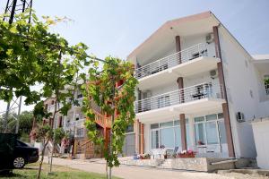 a white apartment building with a balcony at Apartments Vila Dusan in Sutomore
