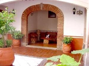 an archway in a room with potted plants at Hotel Reyna Soledad in Zacatecas