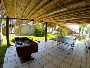 a patio area with a patio table and chairs at Hotel Grandmare & Bungalows in Máncora