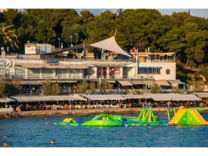 a group of green and yellow boats in the water at IDRO Studio Apartments directly at the beach in Split