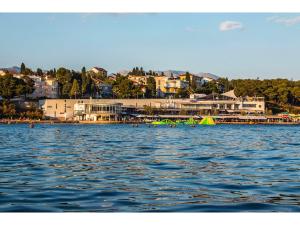 a large body of water with a town in the background at IDRO Studio Apartments directly at the beach in Split