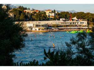 a body of water with people swimming in it at IDRO Studio Apartments directly at the beach in Split