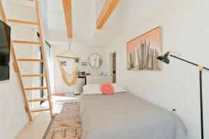 a bedroom with a bed and a ladder at Modern Beach Home Steps To The Sand in San Diego