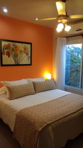 a bedroom with a large bed and a window at Casa Magnolias in Tandil