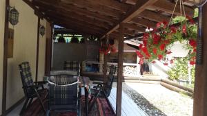 a patio with a table and chairs under a pergola at Nature Villa Sarajevo in Rakovica