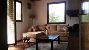 a living room with a couch and a table at Nature Villa Sarajevo in Rakovica