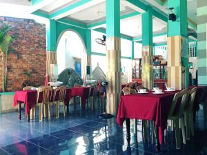 a dining room with red tables and chairs at Trang Vu Homestay Cu Lao Cham in Tân Hiệp +90 photos