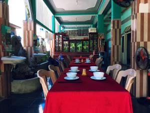 a table in a restaurant with a red table cloth at Trang Vu Homestay Cu Lao Cham in Tân Hiệp