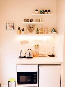 a kitchen with a counter with a microwave at New Market Cozy Room in Auckland