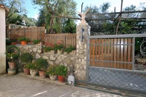 a fence with a bunch of potted plants on it at Casa Vacanze Chery in Sorrento