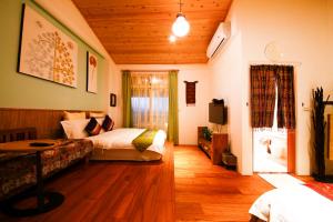 Postel nebo postele na pokoji v ubytování Tang Chao B&B