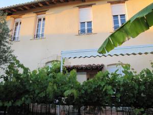 a building with a bunch of trees in front of it at Étape Gimontoise 32 in Gimont