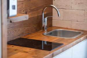 a kitchen with a sink and a wooden counter top at Apartments Sole in Komiža