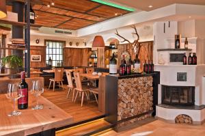 a wine tasting room with a fireplace and tables with wine glasses at Gasthof - Restaurant Hubertushof in Peilstein im Mühlviertel