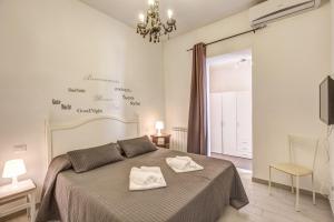 a bedroom with a bed with two towels on it at Relais La Torretta in Rome