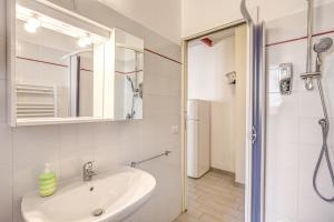 a white bathroom with a sink and a shower at Relais La Torretta in Rome