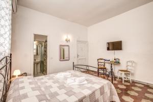 a bedroom with a bed and a table in a room at Relais La Torretta in Rome