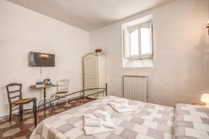 a bedroom with a bed and a table and a window at Relais La Torretta in Rome