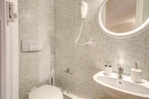 a bathroom with a toilet and a sink and a mirror at Relais La Torretta in Rome