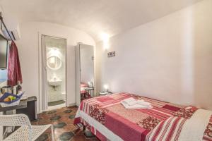 a bedroom with a bed and a sink in it at Relais La Torretta in Rome