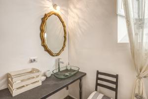 a bathroom with a sink and a mirror on the wall at Relais La Torretta in Rome