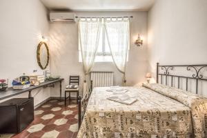 a bedroom with a bed and a table and a window at Relais La Torretta in Rome