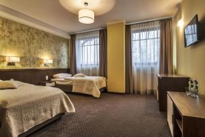 Posteľ alebo postele v izbe v ubytovaní Hotel Tatarscy