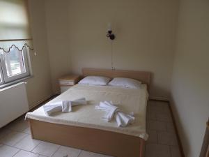 a bedroom with a bed with white towels on it at Hamsilos Apart Hotel in Sinop
