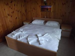 a bed with white sheets and towels on it at Hamsilos Apart Hotel in Sinop