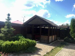 a wooden building with a pavilion in a garden at Arcadia in Kharkiv