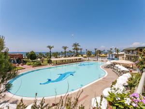 a swimming pool at a resort with a dolphin painted on it at Pine Beach Belek in Belek