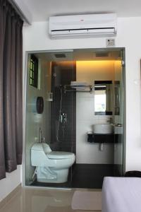 a bathroom with a white toilet and a sink at Time Hotel in Kuala Lumpur