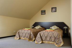 Postel nebo postele na pokoji v ubytování City Center Kaķis B&B