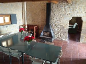 a dining room with a table and a fireplace at Casa Torre Cantoblanco in Barrón