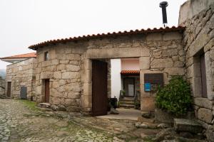 an entrance to a stone building with a doorway at Casa Da Trigueira in Santa Eugénia