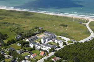 an aerial view of a house next to the beach at Hotel Tannishus in Bindslev