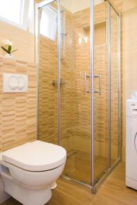 a bathroom with a toilet and a shower at Eni apartments BOL in Bol +29 photos
