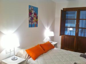 a bedroom with a bed with two lamps and a window at Superb Central Market Apt in Valencia