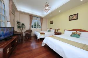 Rúm í herbergi á Yilan Ya Lu Homestay