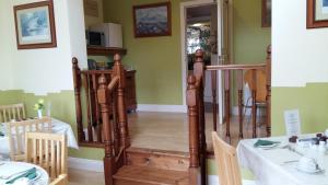 a staircase in a room with a table and chairs at Abacus Guesthouse in Galway