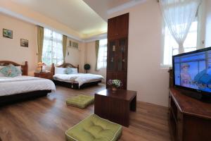 Rúm í herbergi á Yilan Ya Lu Homestay