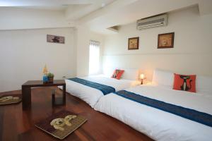 Rúm í herbergi á Yilan Ya Lu Homestay