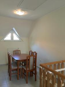 a dining room with a table and chairs and a window at Apartment Altorjai in Fonyód