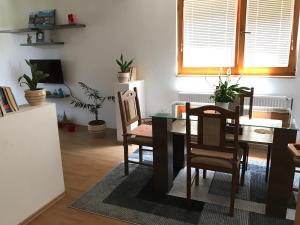 a dining room with a table and chairs at Apartment near the Airport in Sarajevo