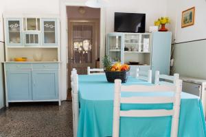 a kitchen with a blue table with fruit on it at Vintage Apartment Nona in Mošćenička Draga +7 photos